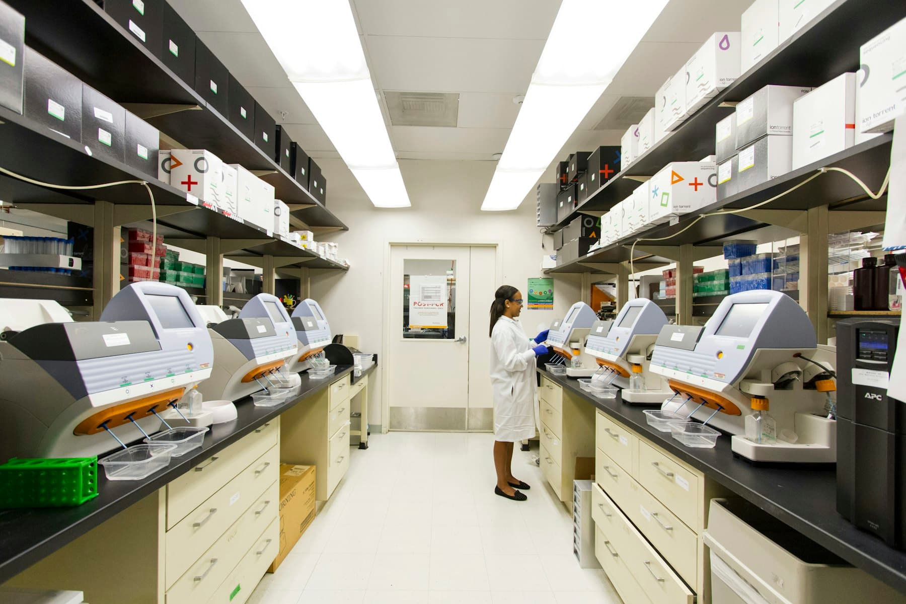 A laboratory professional working with diagnostic equipment. Demonstration imagery — not Peak Mark facilities.